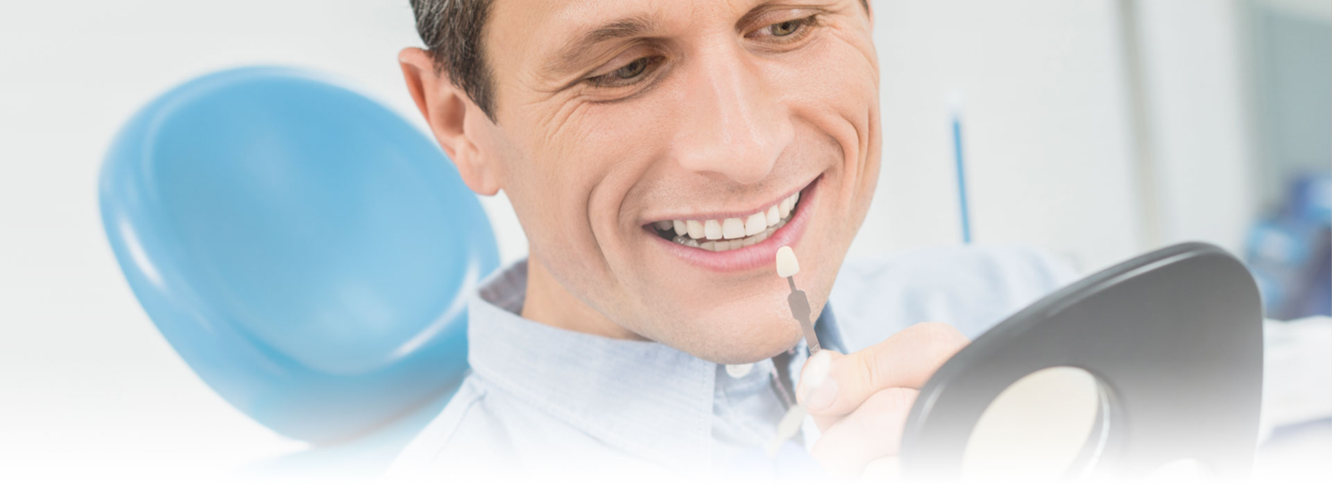Man comparing dental implant at the dental implant at crestwood dental group